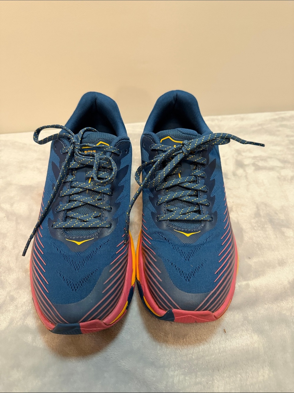 Hoka navy blue running shoes with pink and yellow sole - Picture 2 of 4